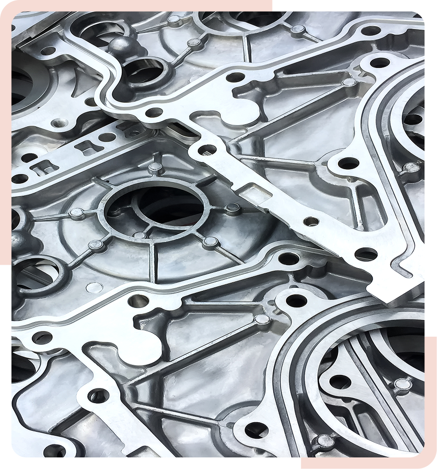Close-up view of stacked metal gear mechanisms with intricate patterns and holes, showcasing industrial engineering and machinery components.